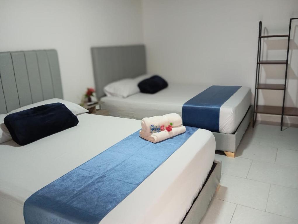 Postel nebo postele na pokoji v ubytování Hotel San Juan 70 Express Medellin