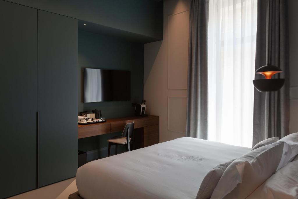 Postel nebo postele na pokoji v ubytování Palazzo Giusti Lecce - Exclusive Boutique hotel