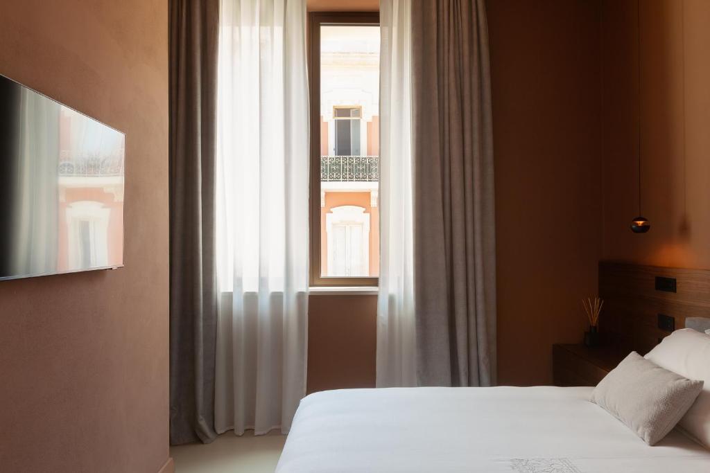 Postel nebo postele na pokoji v ubytování Palazzo Giusti Lecce - Exclusive Boutique hotel