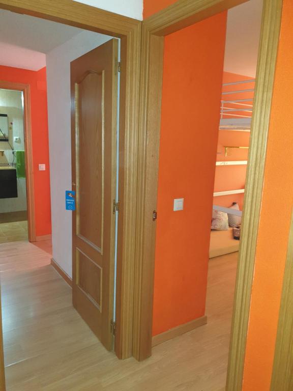 a hallway with orange walls and a closet at DOGGY House&hosting DOGS&FAMILY in Parla