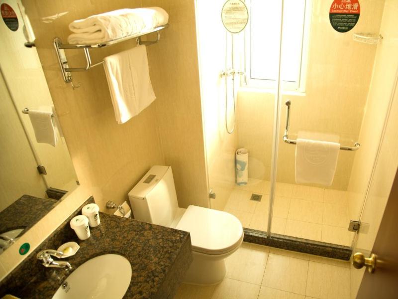 uma casa de banho com um lavatório e um chuveiro. em GreenTree Inn JiangSu HuaiAn University Town Science and Technology Avenue Business Hotel em Huai'an