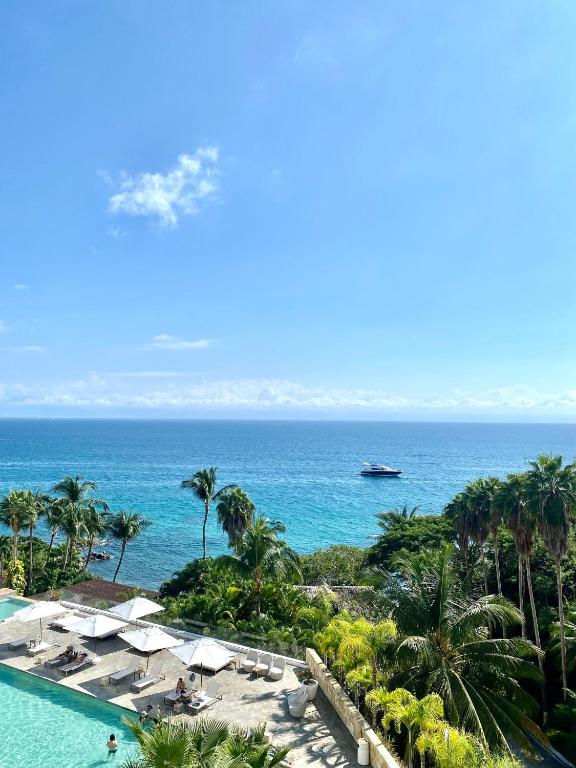 a view of the ocean from a resort with a swimming pool at Arena Bca in Cruz de Huanacaxtle