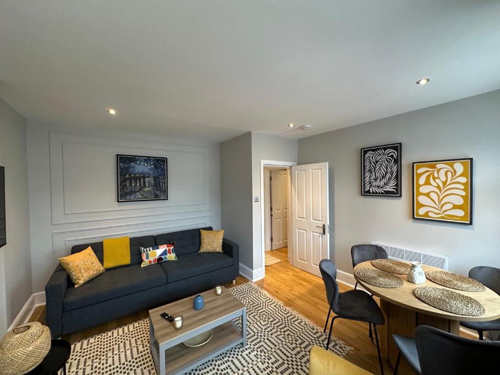 a living room with a couch and a table at Brand New Flat in Central London in London