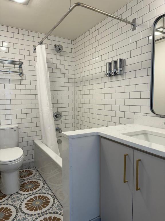 a white bathroom with a sink and a toilet at Norblad Hotel in Astoria, Oregon