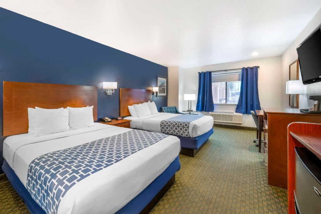 a hotel room with two beds and a television at Best Western Parker Inn in Parker