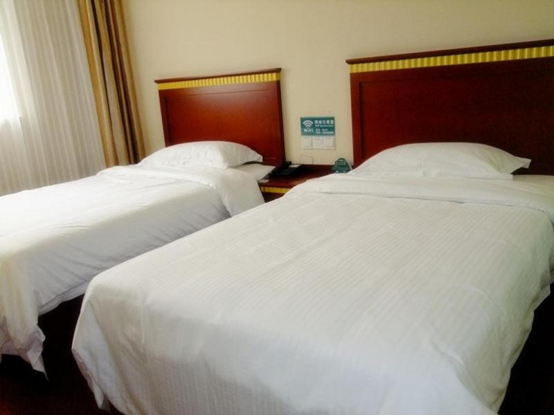 2 łóżka w pokoju hotelowym z białą pościelą w obiekcie GreenTree Inn Anhui Xuancheng South Zhaoting Road Business Hotel w mieście Xuanzhou