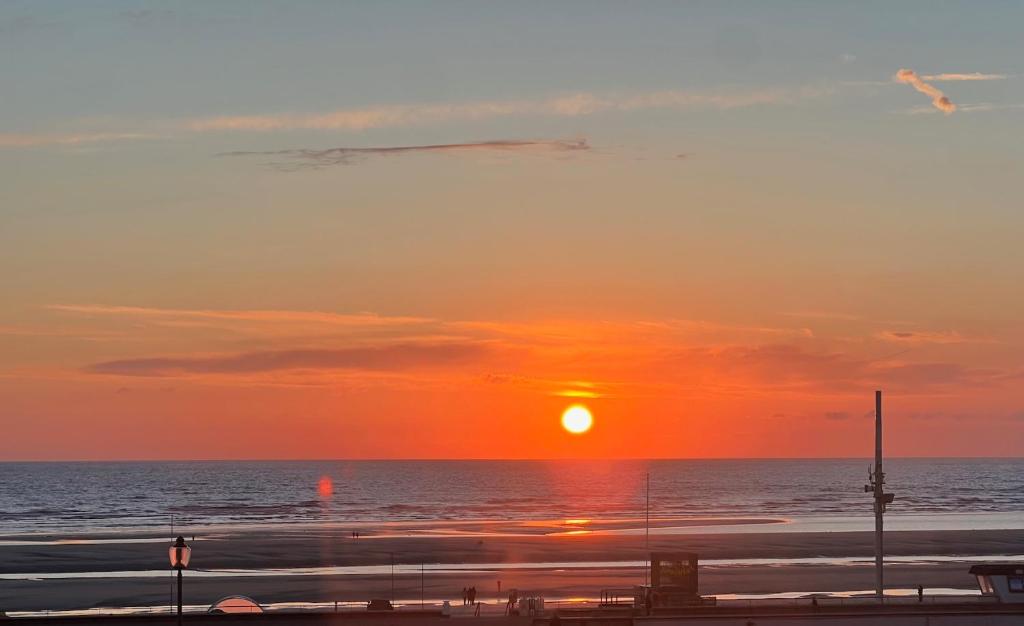 - un coucher de soleil sur la plage dans l'établissement L'Eau Vive 2 Front de mer 2e étage, à Le Touquet-Paris-Plage