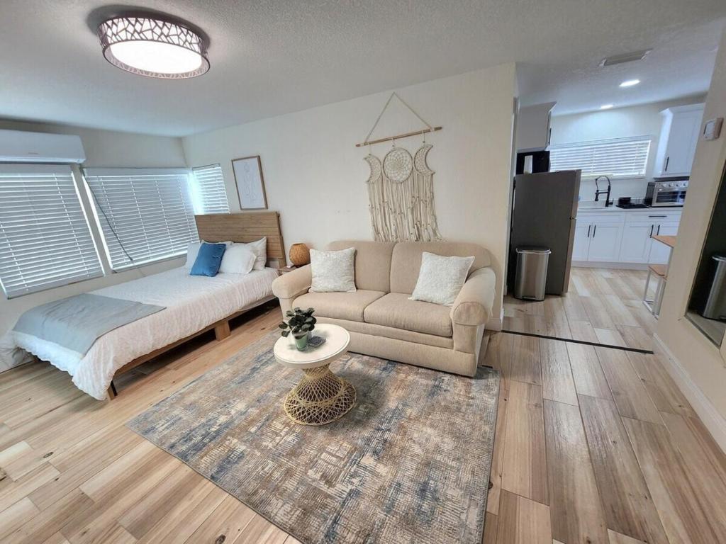 a living room with a couch and a table at Charming And Cosy, Newly Remodeled St Petersburg in St Petersburg