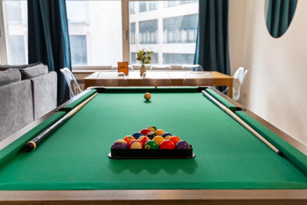 a pool table with a pile of balls on it at Cozy Antwerp - City Family Apartment with Parking in Antwerp