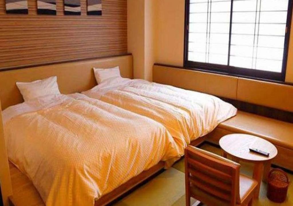 Postel nebo postele na pokoji v ubytování Hotel Yume-no-yu