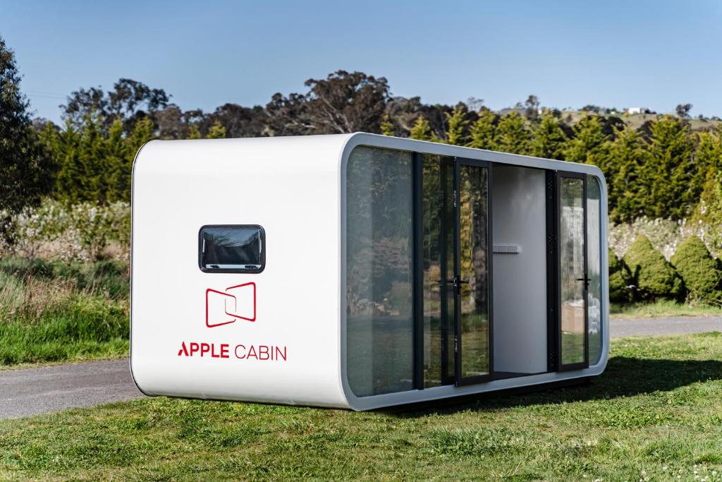 an apple caravan on the side of a road at Field Tiny Home - Fruit & Sunset in Hall