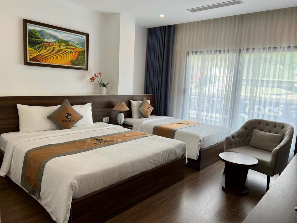 Giường trong phòng chung tại Silk River Hotel Ha Giang