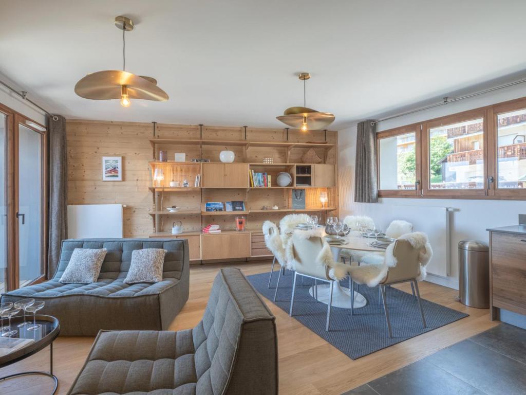un salon avec une table et un canapé dans l'établissement Duplex neuf avec balcon, cheminée, proche des pistes à l'Alpe d'Huez - FR-1-645-73, à Huez