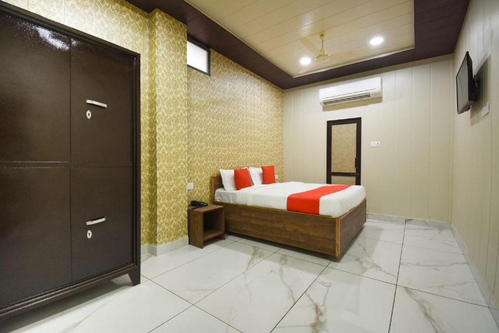 a bedroom with a bed and a closet in a room at OYO Flagship 62786 Hotel New Delhi in Patiāla
