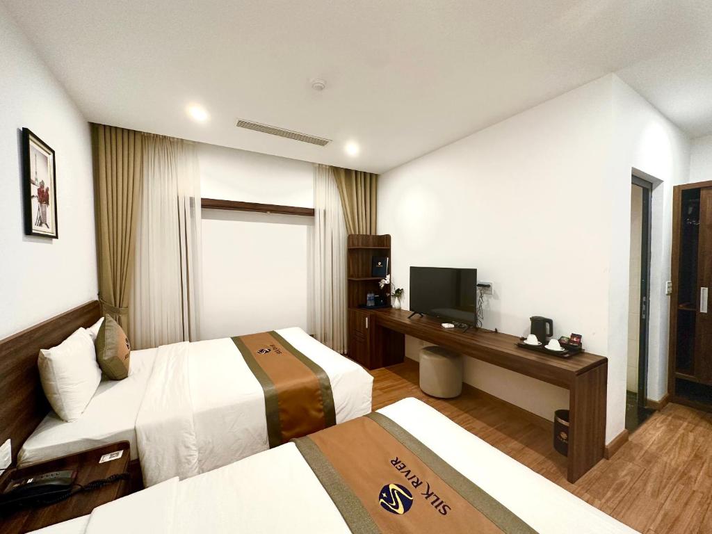 Giường trong phòng chung tại Silk River Hotel Ha Giang