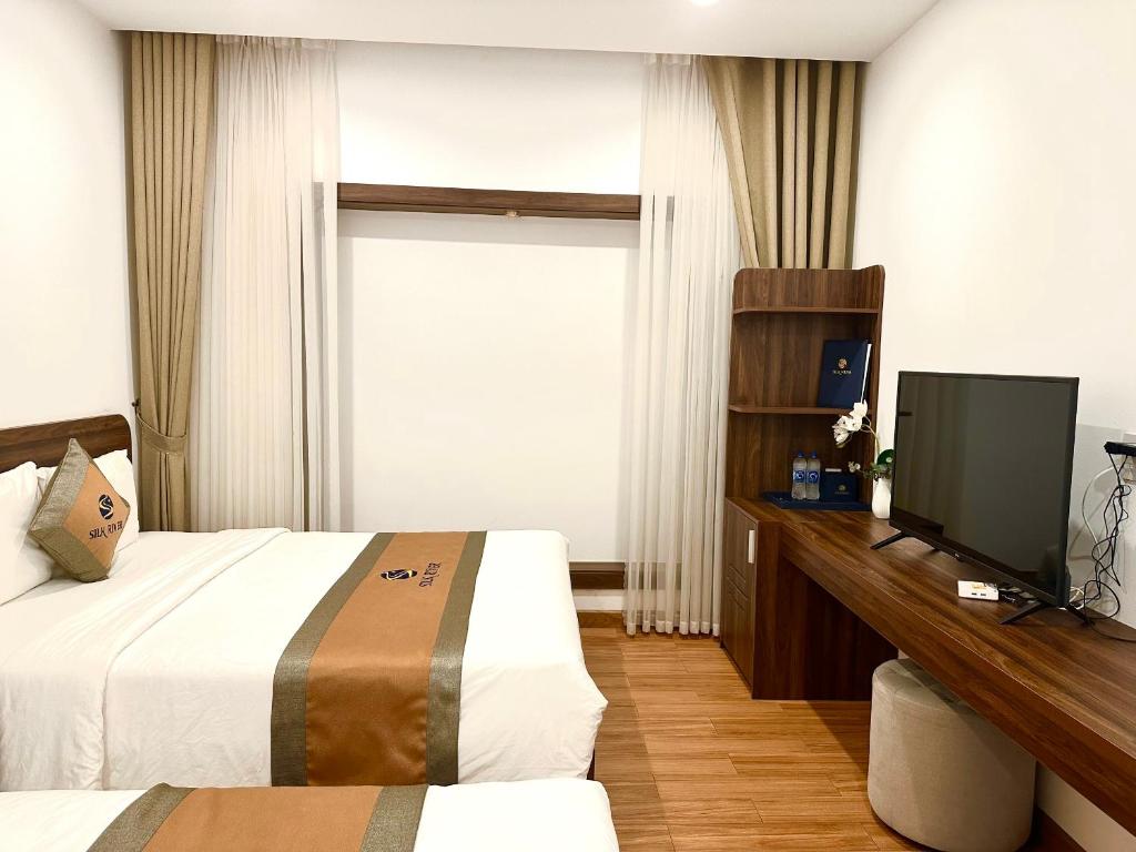 Giường trong phòng chung tại Silk River Hotel Ha Giang