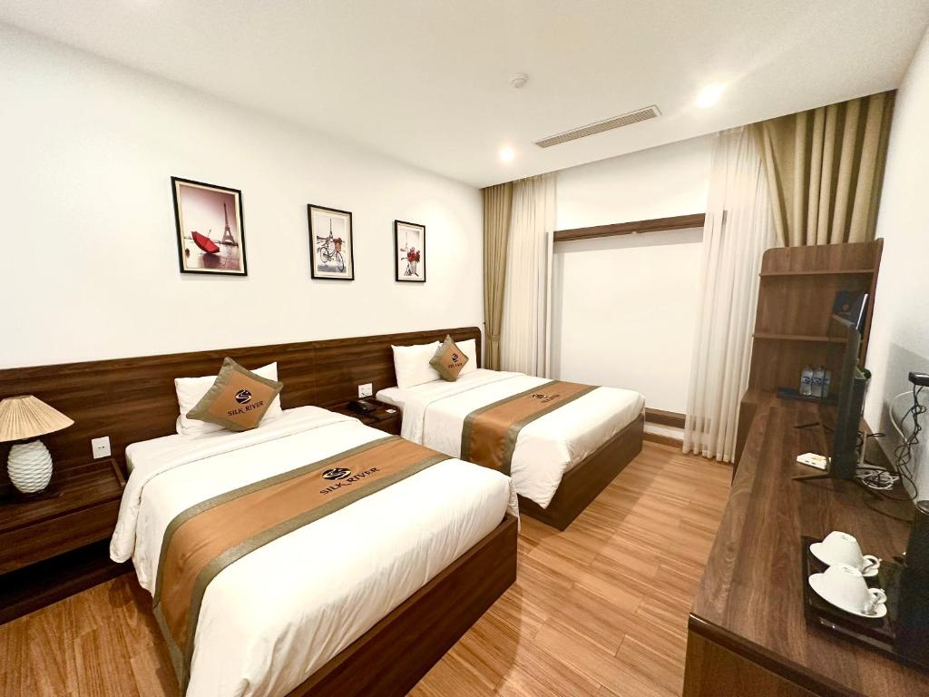 Giường trong phòng chung tại Silk River Hotel Ha Giang
