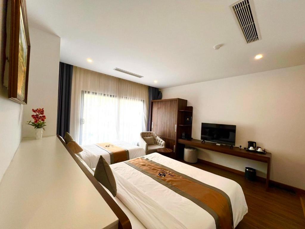 Giường trong phòng chung tại Silk River Hotel Ha Giang