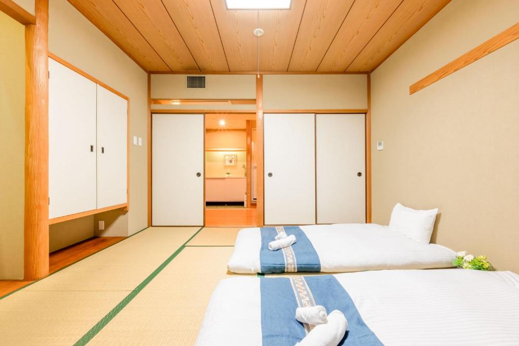 Postel nebo postele na pokoji v ubytování Plaza In Miyakojima hotel