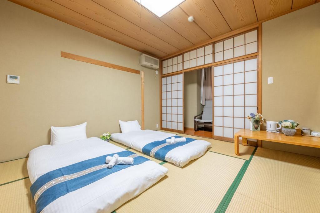 Postel nebo postele na pokoji v ubytování Plaza In Miyakojima hotel