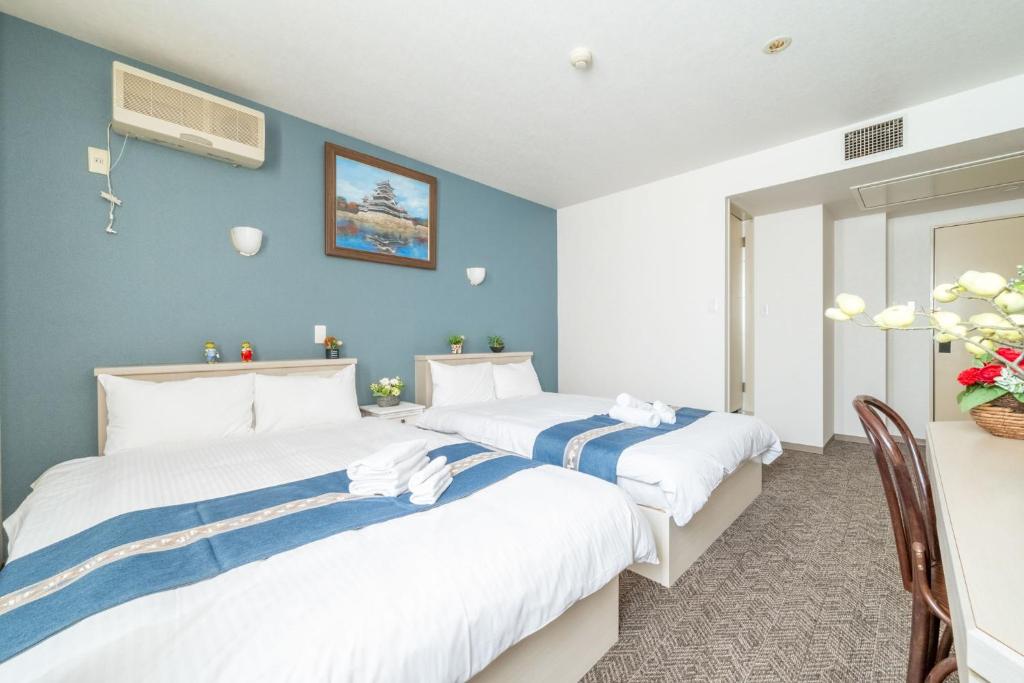 Postel nebo postele na pokoji v ubytování Plaza In Miyakojima hotel