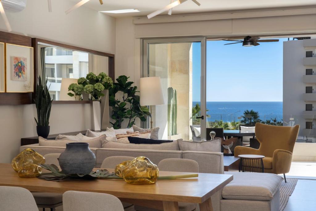 a living room with a couch and a table at Luxury Beachfront Apartment in Cabo in Cabo San Lucas
