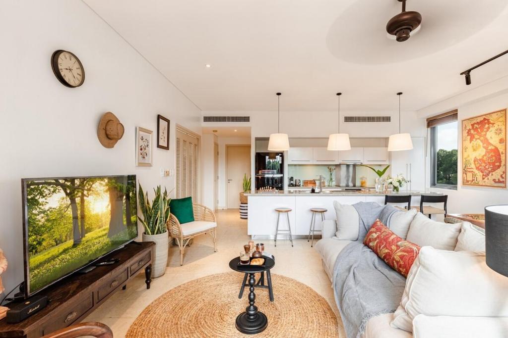 a living room with a couch and a tv at De Old Sport - Vesta Collections in Ho Chi Minh City