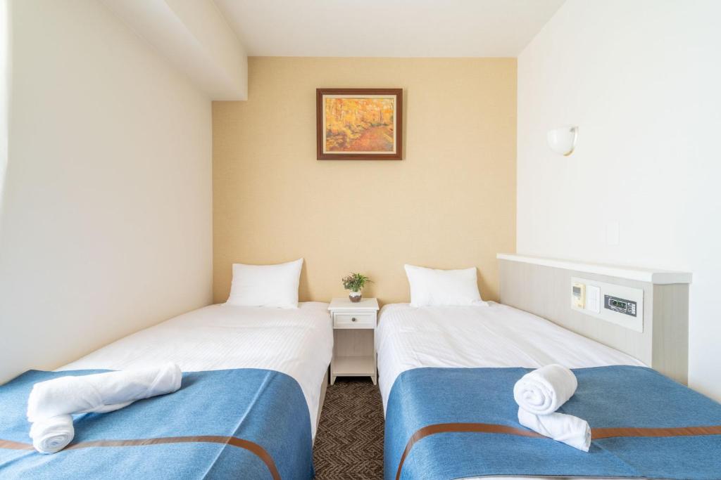 Postel nebo postele na pokoji v ubytování Plaza In Miyakojima hotel