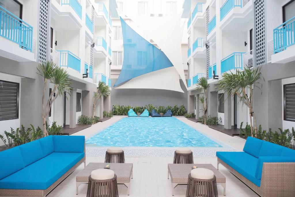 an image of a swimming pool in a building at Bloo Bali Hotel in Legian