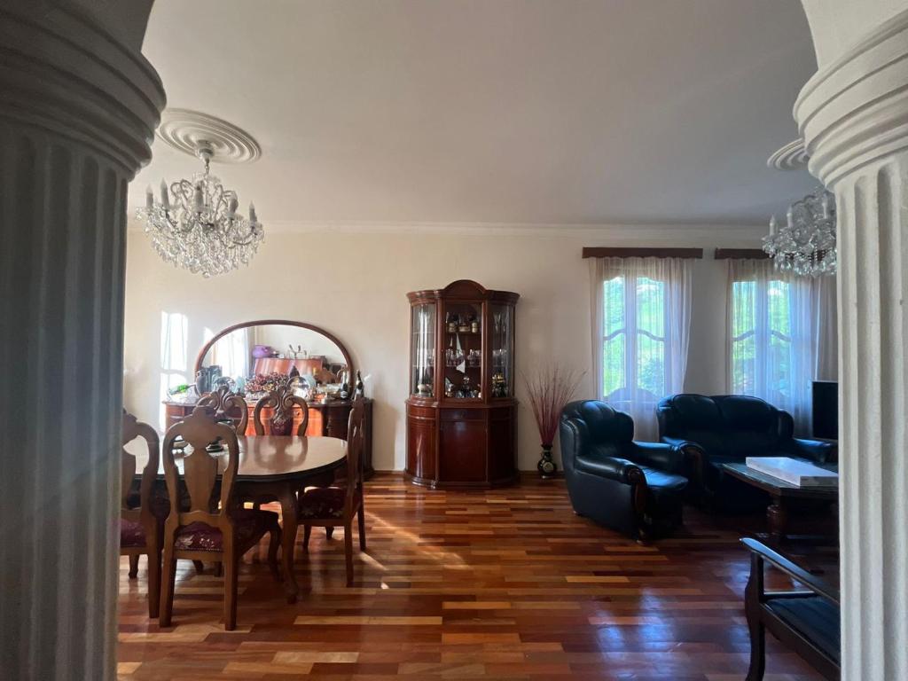 a living room with a table and a dining room at Home in paradise in Tofaloglebi