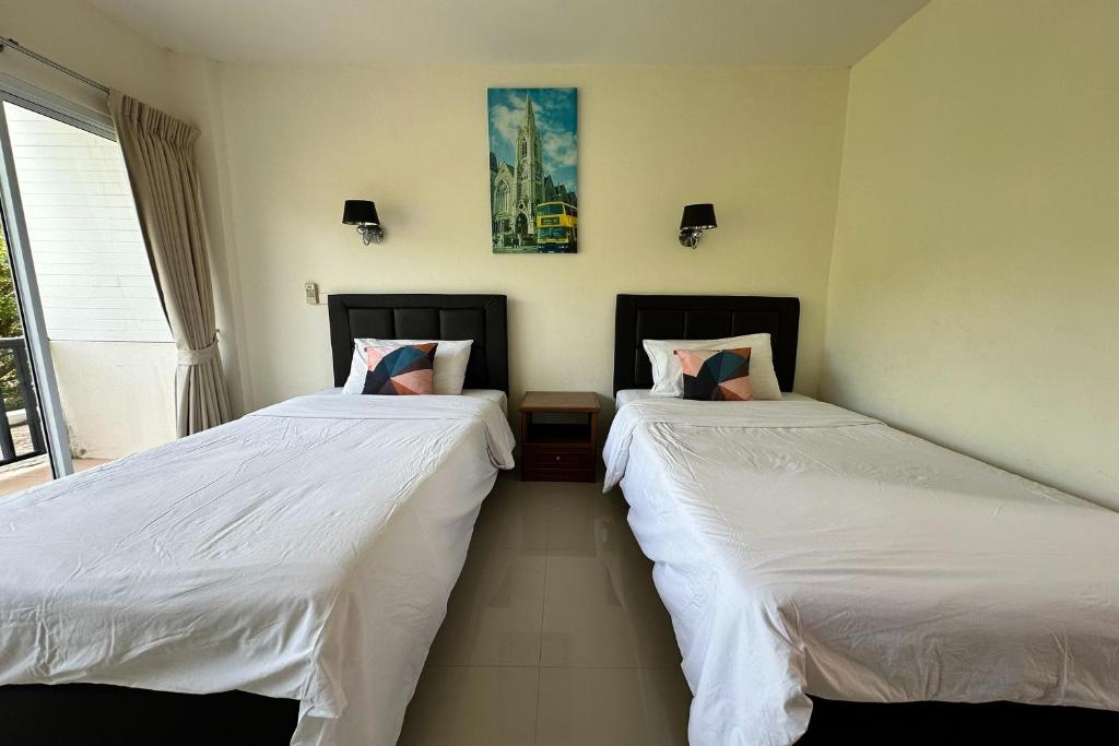 Postel nebo postele na pokoji v ubytování Choengmon Residence