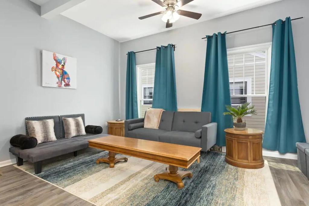 a living room with a couch and a table at Recently Renovated Chic Durham Farmhouse in Durham