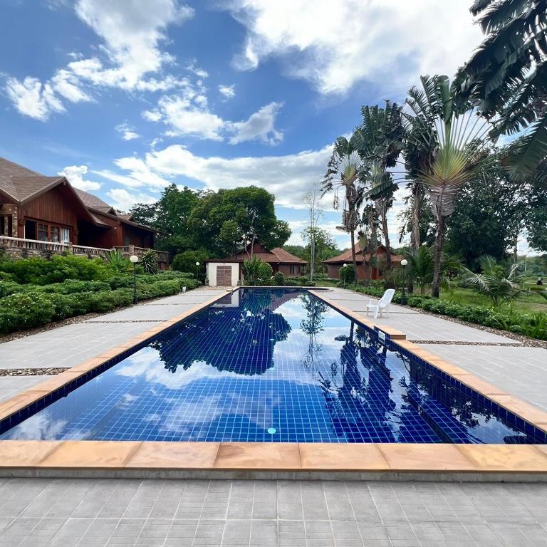 a swimming pool with blue water in a house at Sasidara Resort Nan in Nan