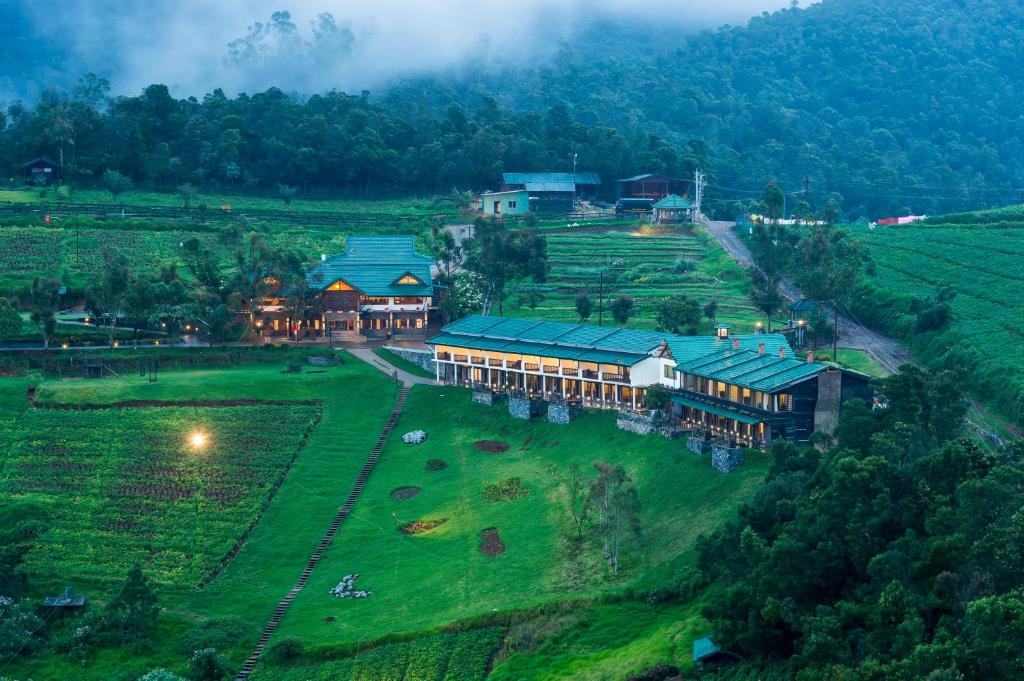 an aerial view of a building in a field at Destiny - The Farm Resort in Ooty