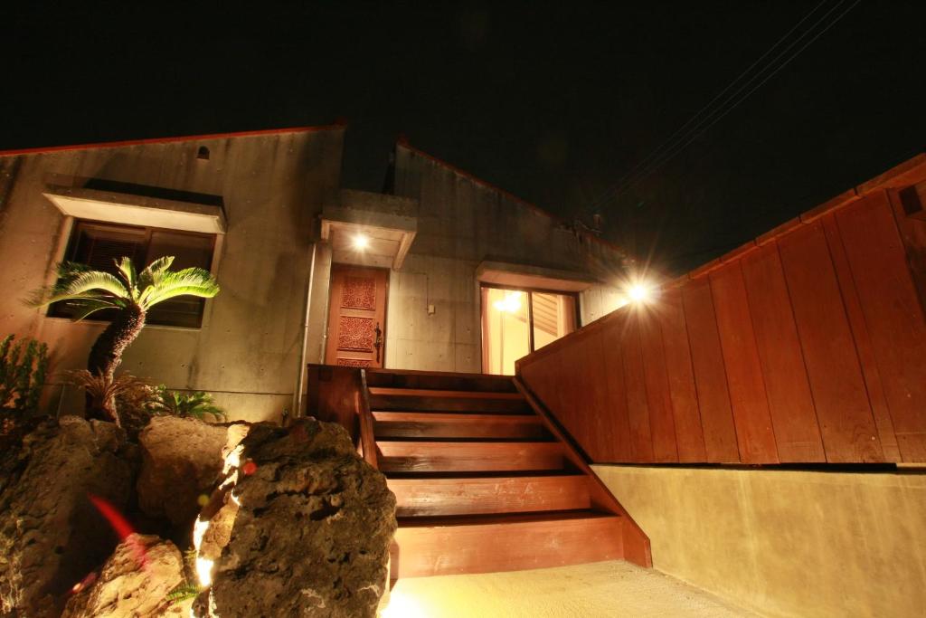 a building with a staircase with a light on it at Cottage Hakuraku in Onna