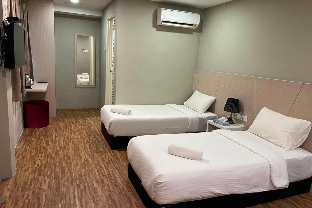 Postel nebo postele na pokoji v ubytování Princess Hotel Pontian
