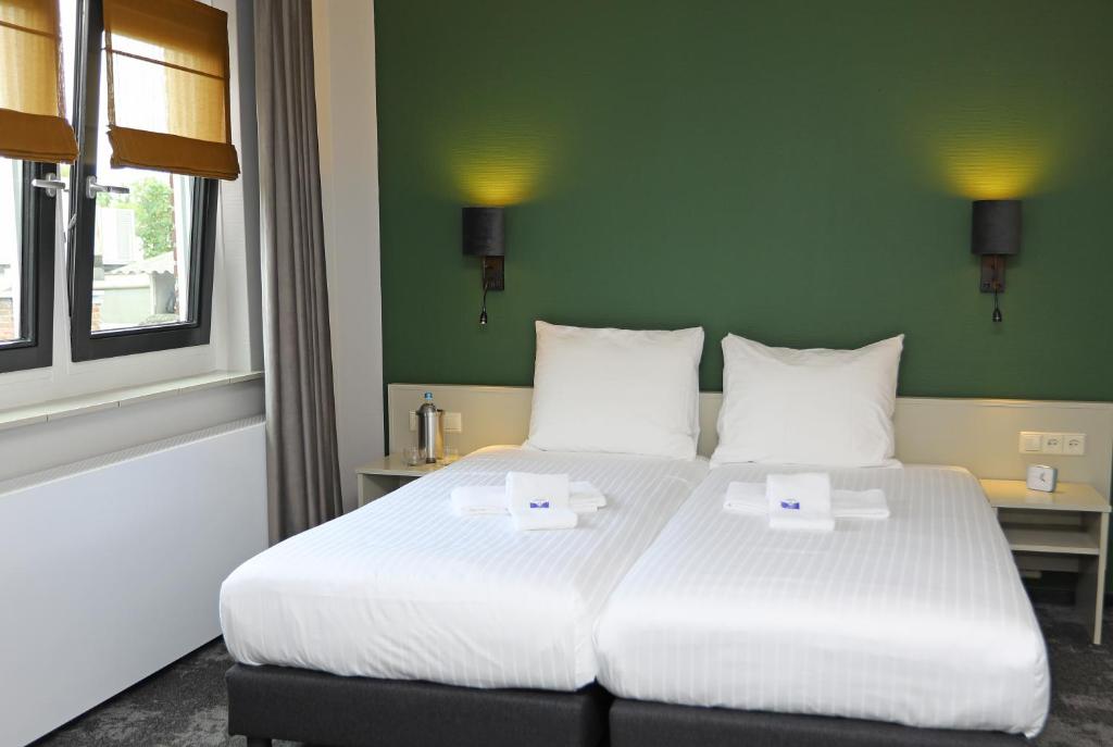 Postel nebo postele na pokoji v ubytování Hotel Bi-j Ons