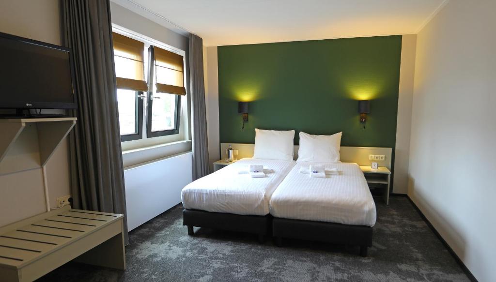 Postel nebo postele na pokoji v ubytování Hotel Bi-j Ons