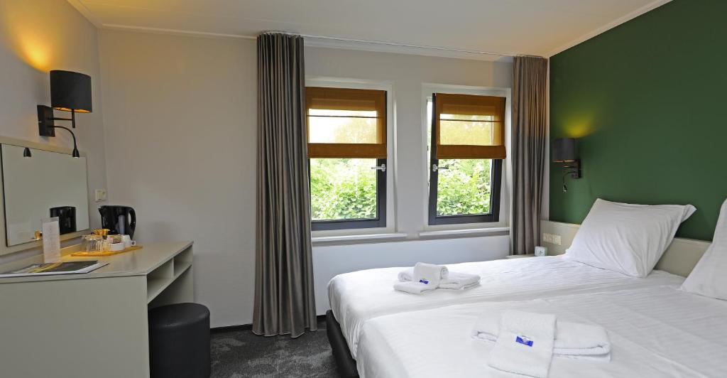 Postel nebo postele na pokoji v ubytování Hotel Bi-j Ons