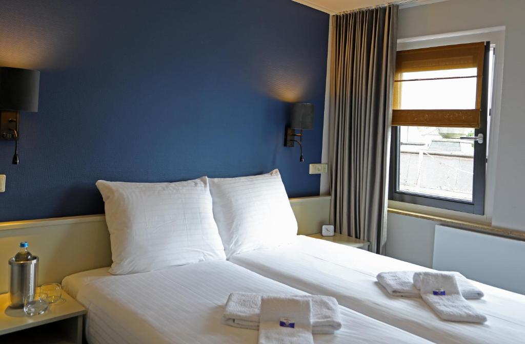 Postel nebo postele na pokoji v ubytování Hotel Bi-j Ons