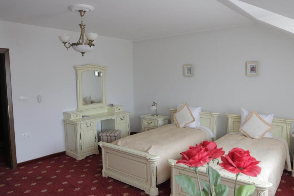 Postel nebo postele na pokoji v ubytování Hotel Slavia