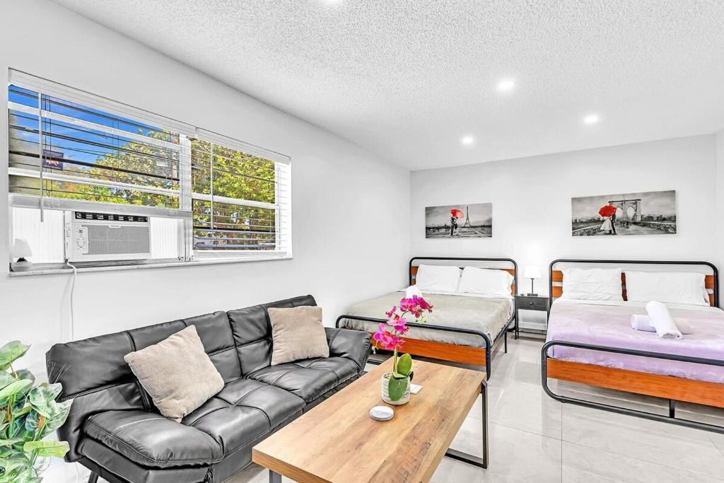 a living room with a couch and a bed at New 2 Bed Studio Close To Beach & Casino Ha04 in Hollywood