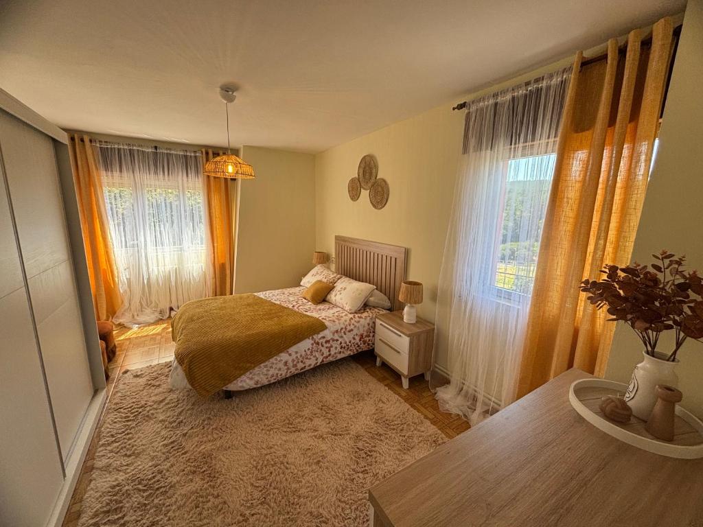 a bedroom with a bed and a large window at Casa de Mucha in Camariñas
