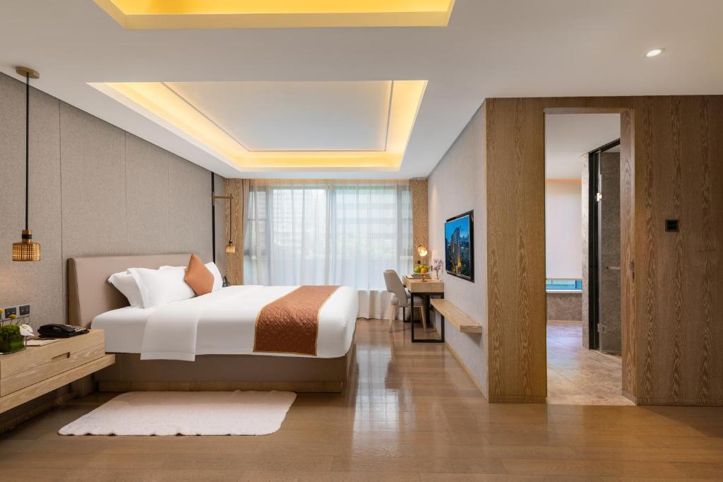 Postel nebo postele na pokoji v ubytování Shenzhen FY Hotel