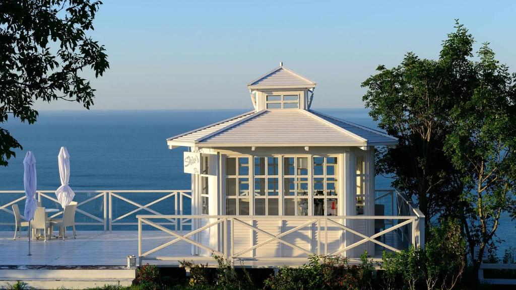 a large white gazebo with a table and chairs at SeaView Golf Villa in Balchik