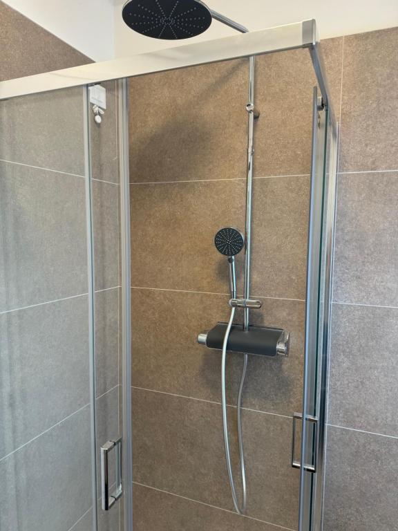 a shower with a glass door in a bathroom at Iris home in Favaro Veneto
