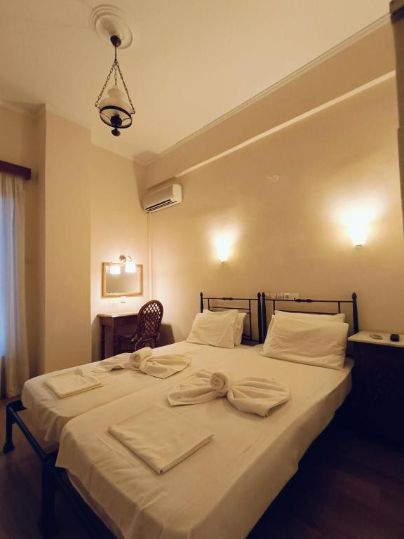 Postel nebo postele na pokoji v ubytování Anesis Hotel
