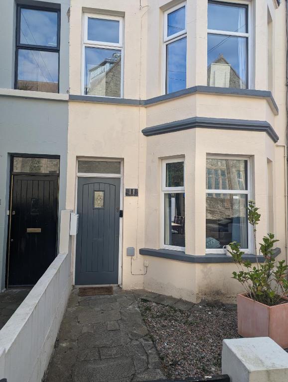 a house with a blue door and windows at Prospect House - Elegant 4-Bed Family Escape Near Ward Park & Marina in Bangor