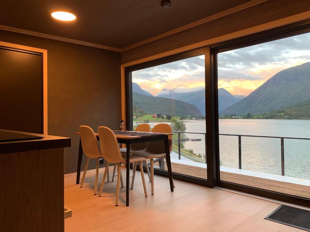 a dining room with a table and chairs and a large window at Stryn Golden Resort - Panorama II in Stryn