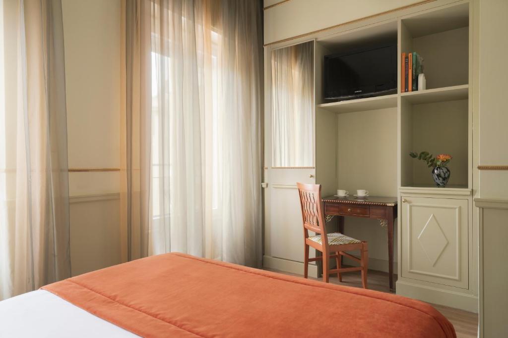 Postel nebo postele na pokoji v ubytování Hotel Degli Aranci